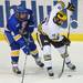 Michigan sophomore Luke Moffatt moves the puck around Lake Superior State junior Zach Trotman in the first period at Yost Arena on Friday night. Melanie Maxwell I AnnArbor.com